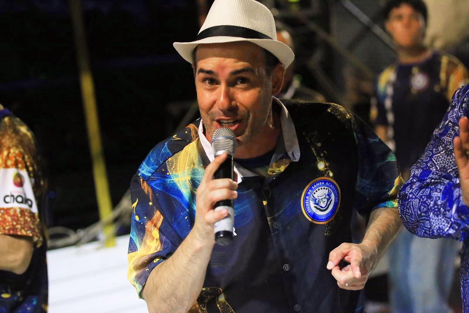 Announcer with microphone and hat during the parade broadcast