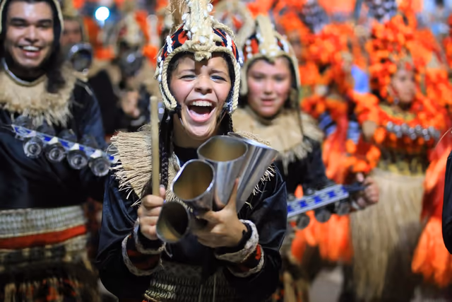 Académicos musicians with drums and orange feather headdresses