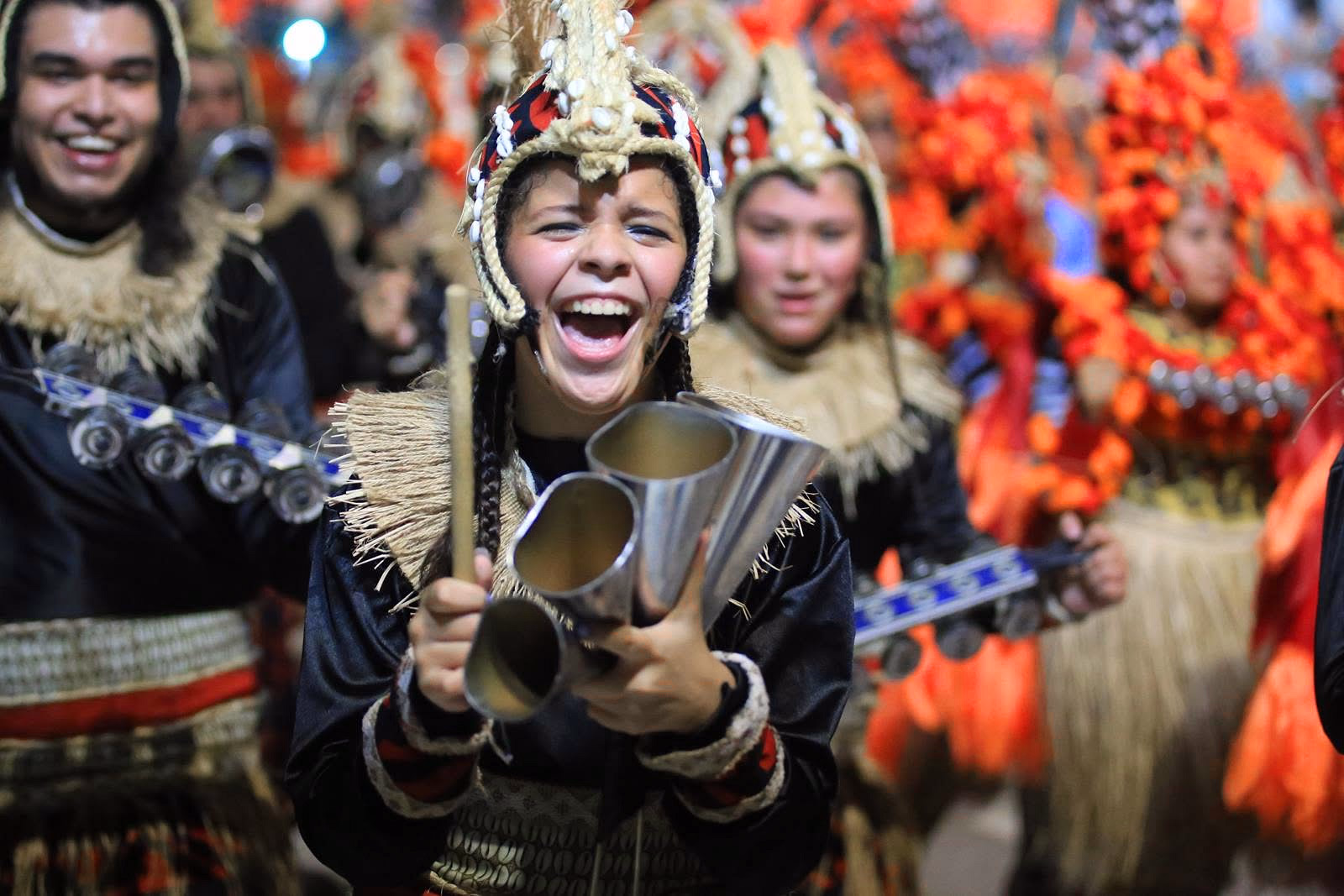Académicos musicians with drums and orange feather headdresses