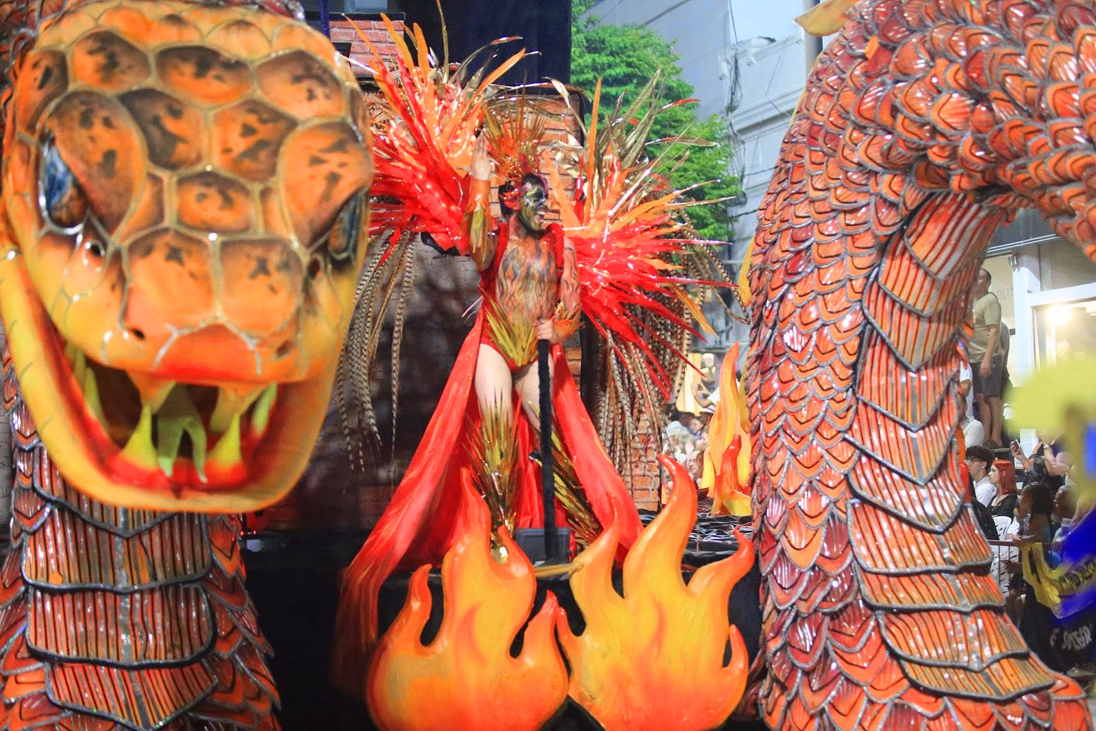 Orange dragon breathing fire on the Académicos float
