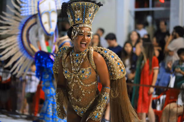 Barrio Rampla featured dancer with blue and white feathers