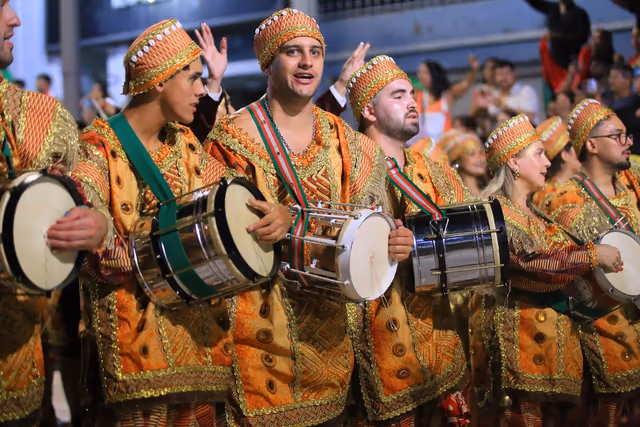 Barrio Rampla drum section with drums and gold costumes
