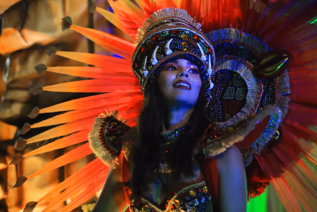 Barrio Rampla featured dancer with a red feather headdress