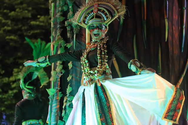 Performer in green with a white dress in the Barrio Rampla parade