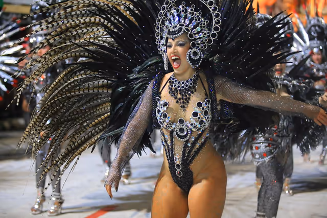 Barrio Rampla featured dancer with black and sky-blue feathers