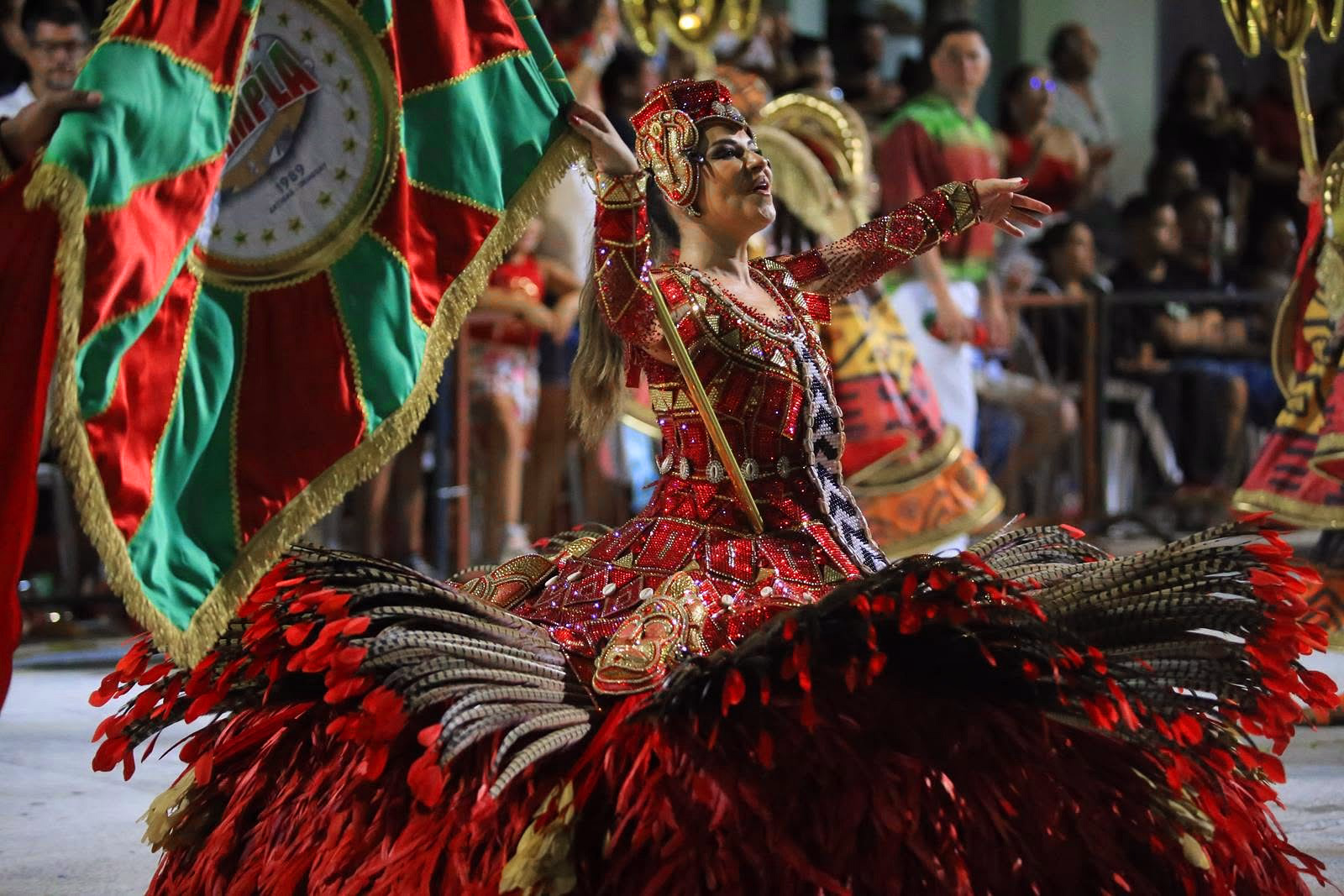 Barrio Rampla featured dancer with red and green feathers