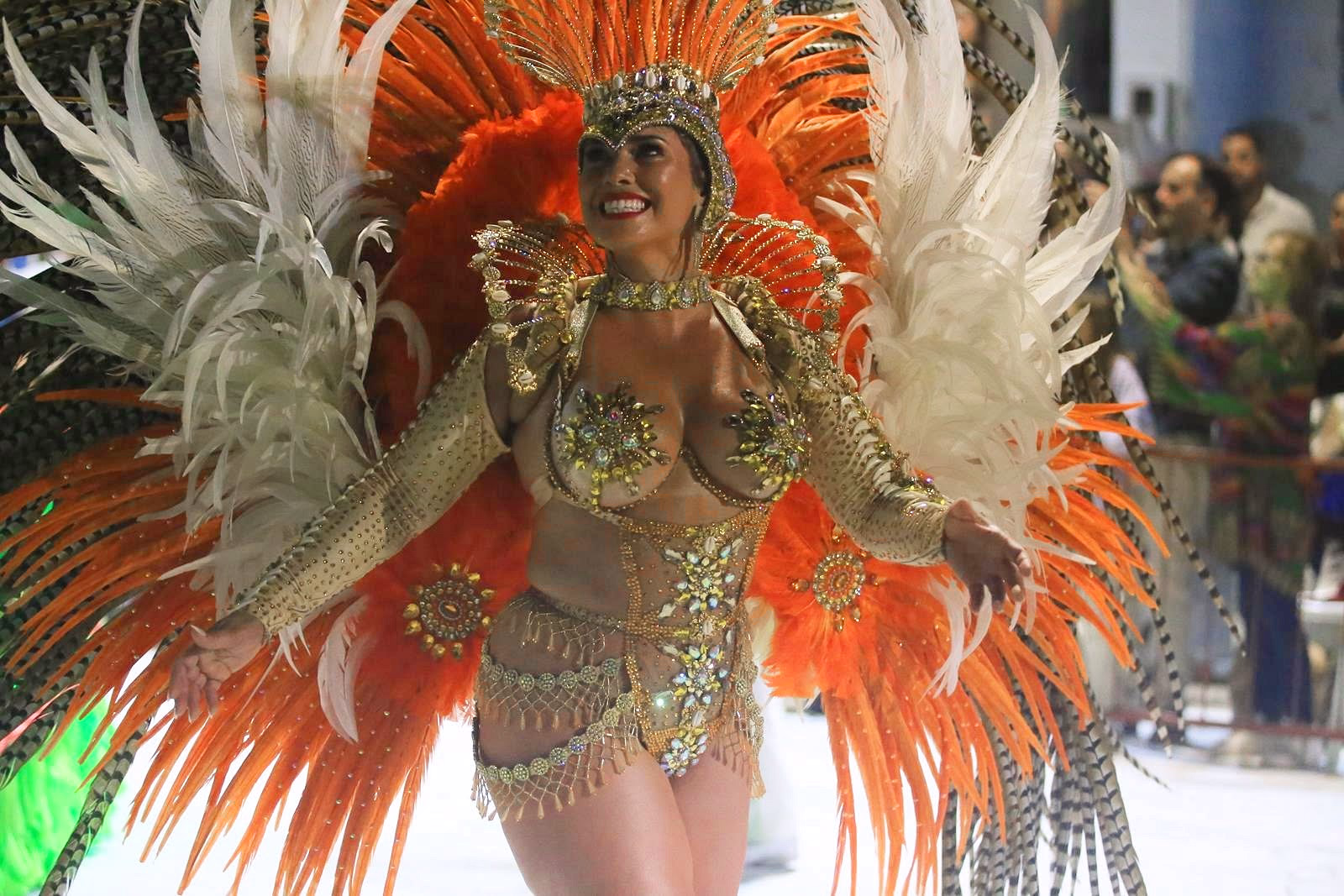 Barrio Rampla featured dancer with orange and white feathers